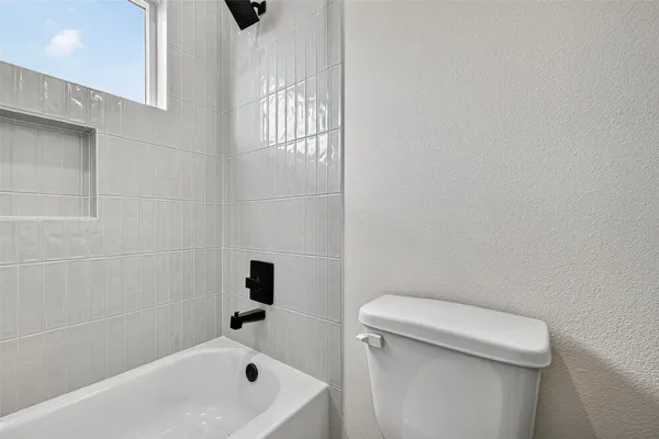a bathroom with a toilet and bathtub