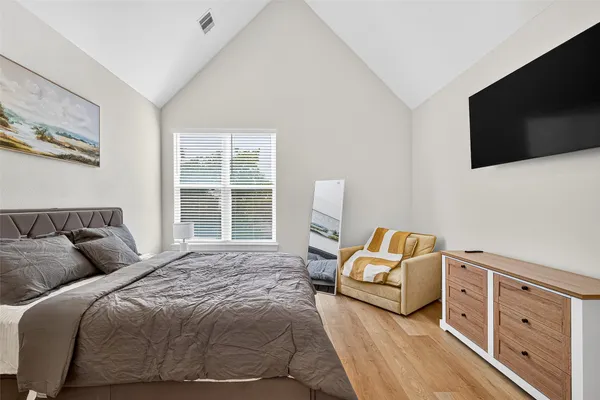 a bedroom with a bed and a flat screen tv