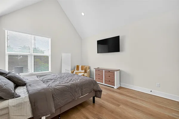 a bedroom with a bed and a flat screen tv