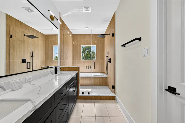 a bathroom with a granite countertop sink a toilet and shower