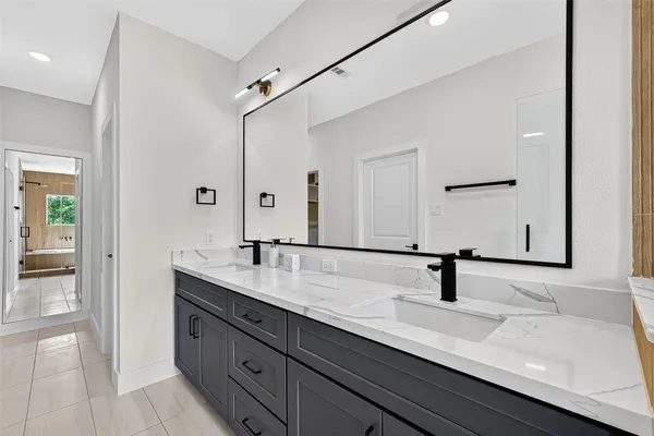 a bathroom with a sink and mirror