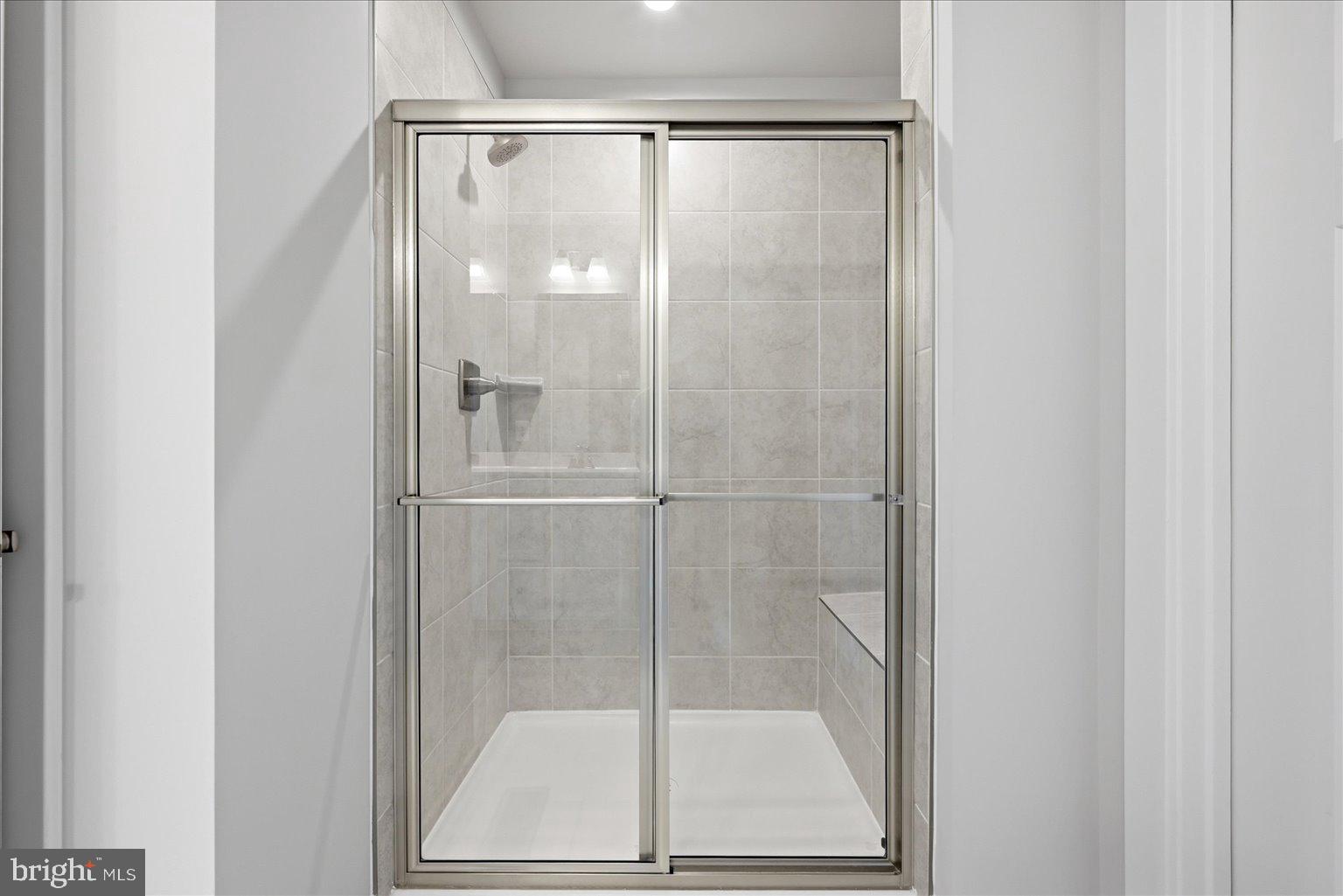 14380 Longhouse Loop Brandywine, MD 20613 - Photo 9 of 20 a bathroom with a glass shower door