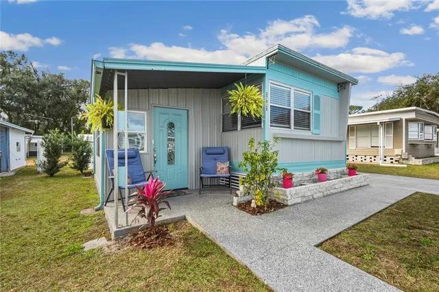a house view with a sitting space fire pit and outdoor space