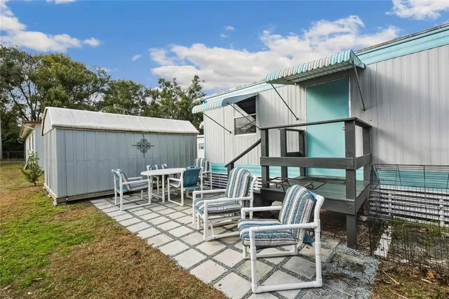 a backyard of a house with table and chairs