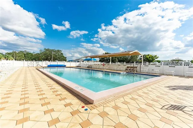 a view of swimming pool with outdoor seating