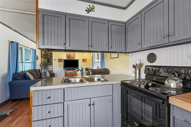 a kitchen with a sink stove and cabinets