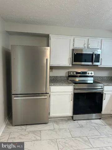 a kitchen with appliances and cabinets