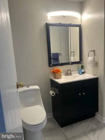 a bathroom with a sink vanity and a mirror