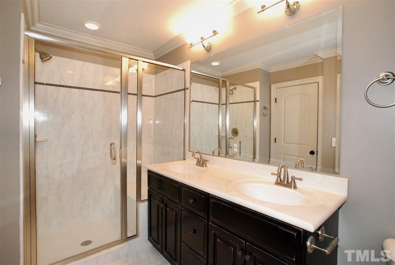 8012 Lloyd Allyns Way Raleigh, NC 27615 - Photo 18 of 25 Bath has Dual Vanity & Oversized Shower with a Built-in Sitting Area.
