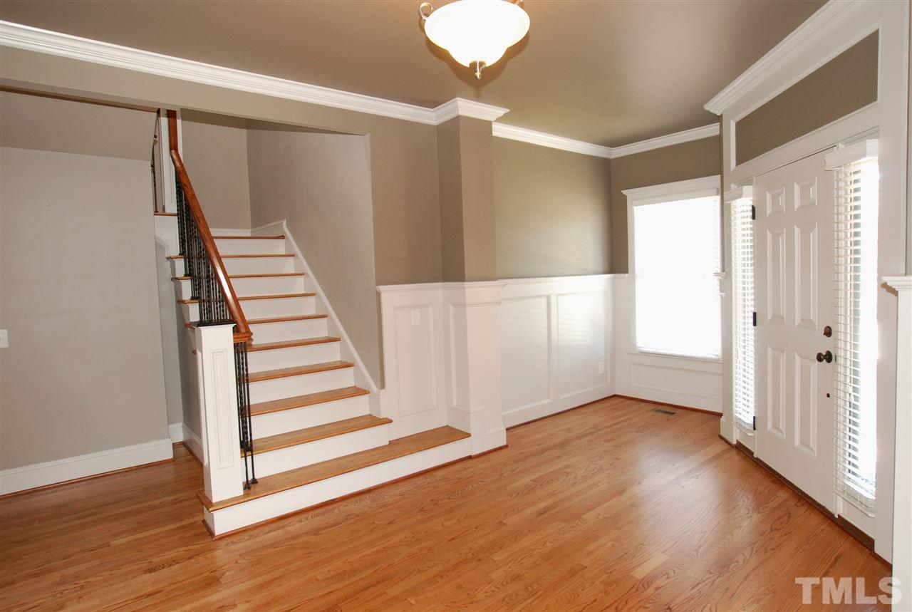8012 Lloyd Allyns Way Raleigh, NC 27615 - Photo 3 of 25 Large Foyer with Gleaming Hardwoods & Wainscoting Trim.