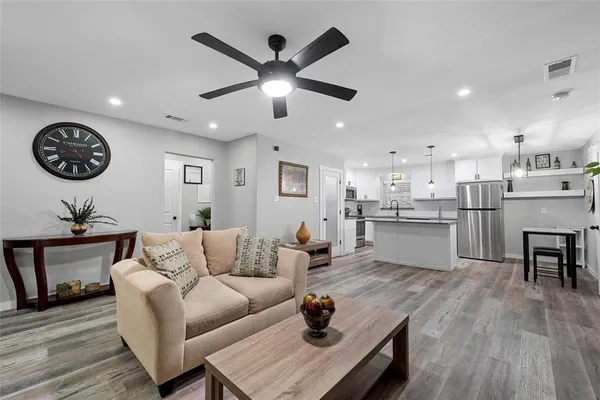 a living room with furniture and kitchen view