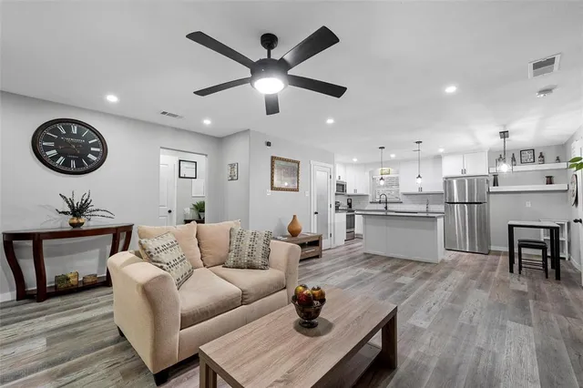 a living room with furniture and kitchen view