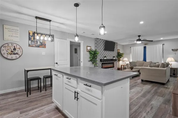 an aerial view of a house with a yard and a large tree