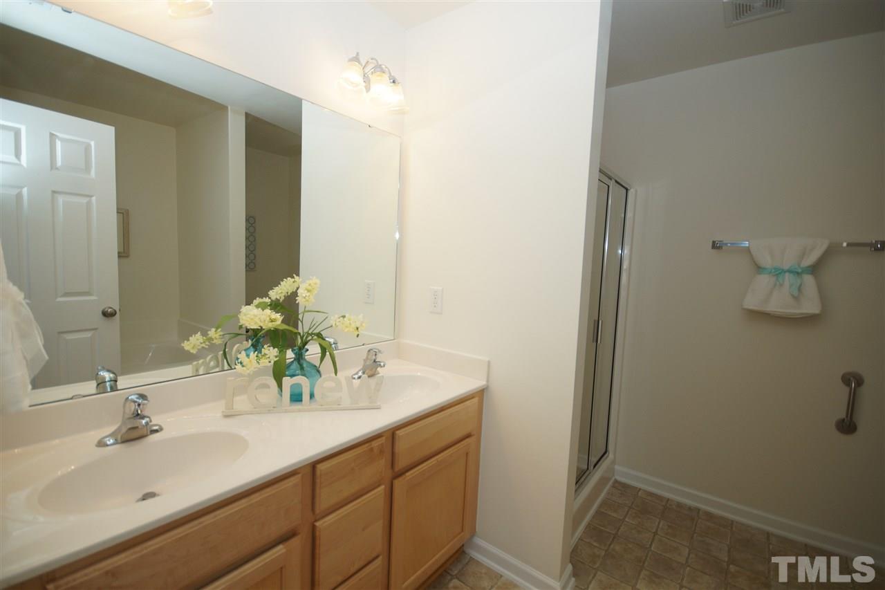 8235 Belneath Court Raleigh, NC 27613 - Photo 12 of 17 a bathroom with a sink and a mirror