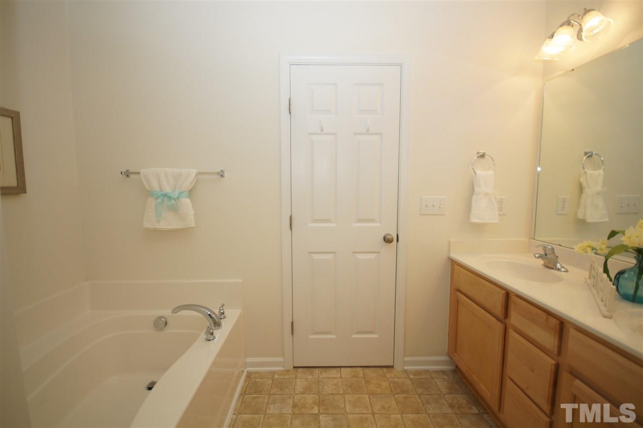 8235 Belneath Court Raleigh, NC 27613 - Photo 13 of 17 a bathroom with a tub sink and mirror