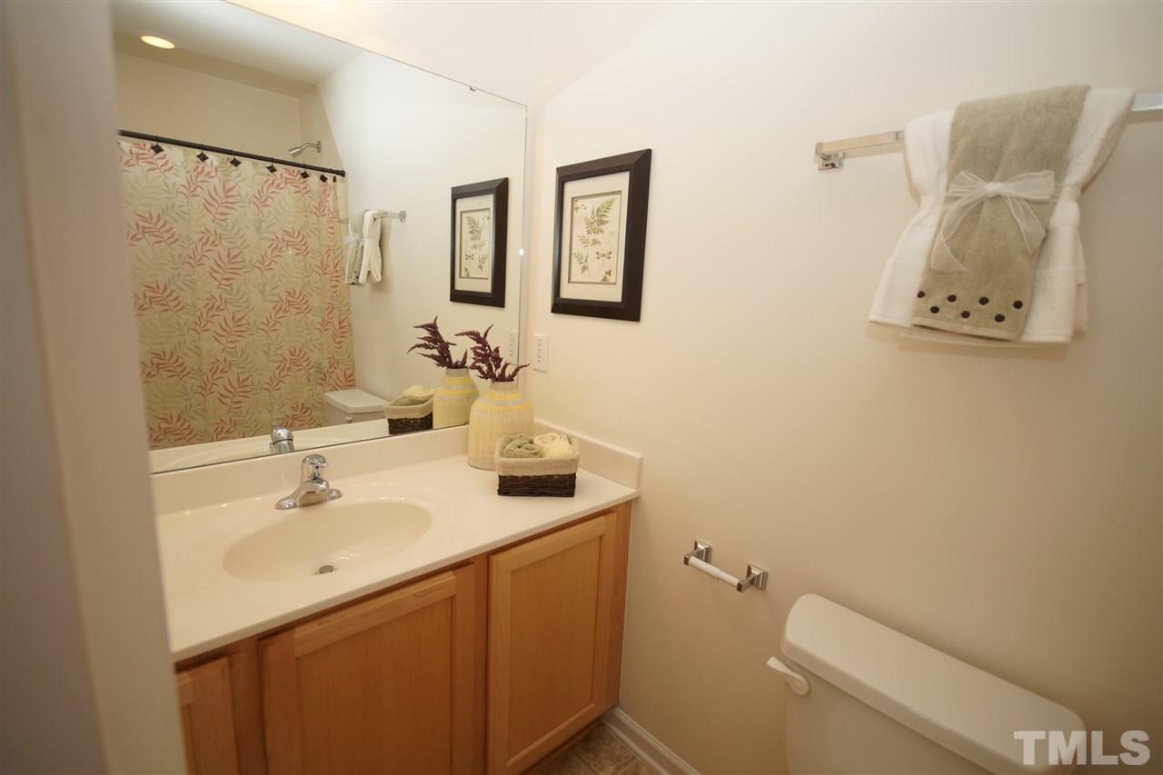 8235 Belneath Court Raleigh, NC 27613 - Photo 15 of 17 a bathroom with a sink mirror vanity and toilet