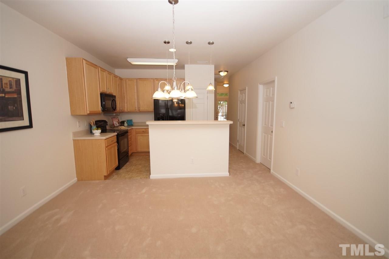 8235 Belneath Court Raleigh, NC 27613 - Photo 5 of 17 a view of a kitchen with kitchen island wooden floor and windows