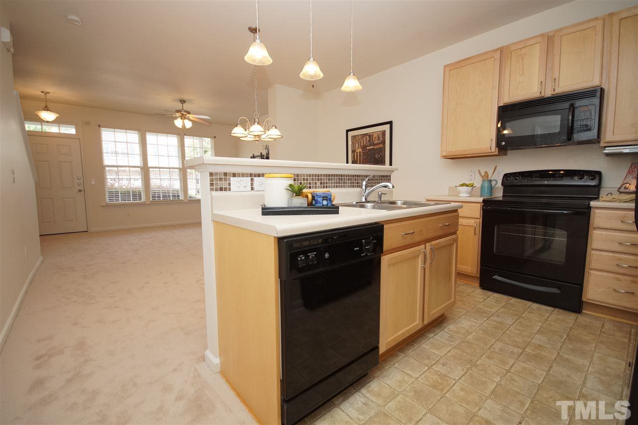 8235 Belneath Court Raleigh, NC 27613 - Photo 7 of 17 a kitchen with a sink stove and microwave