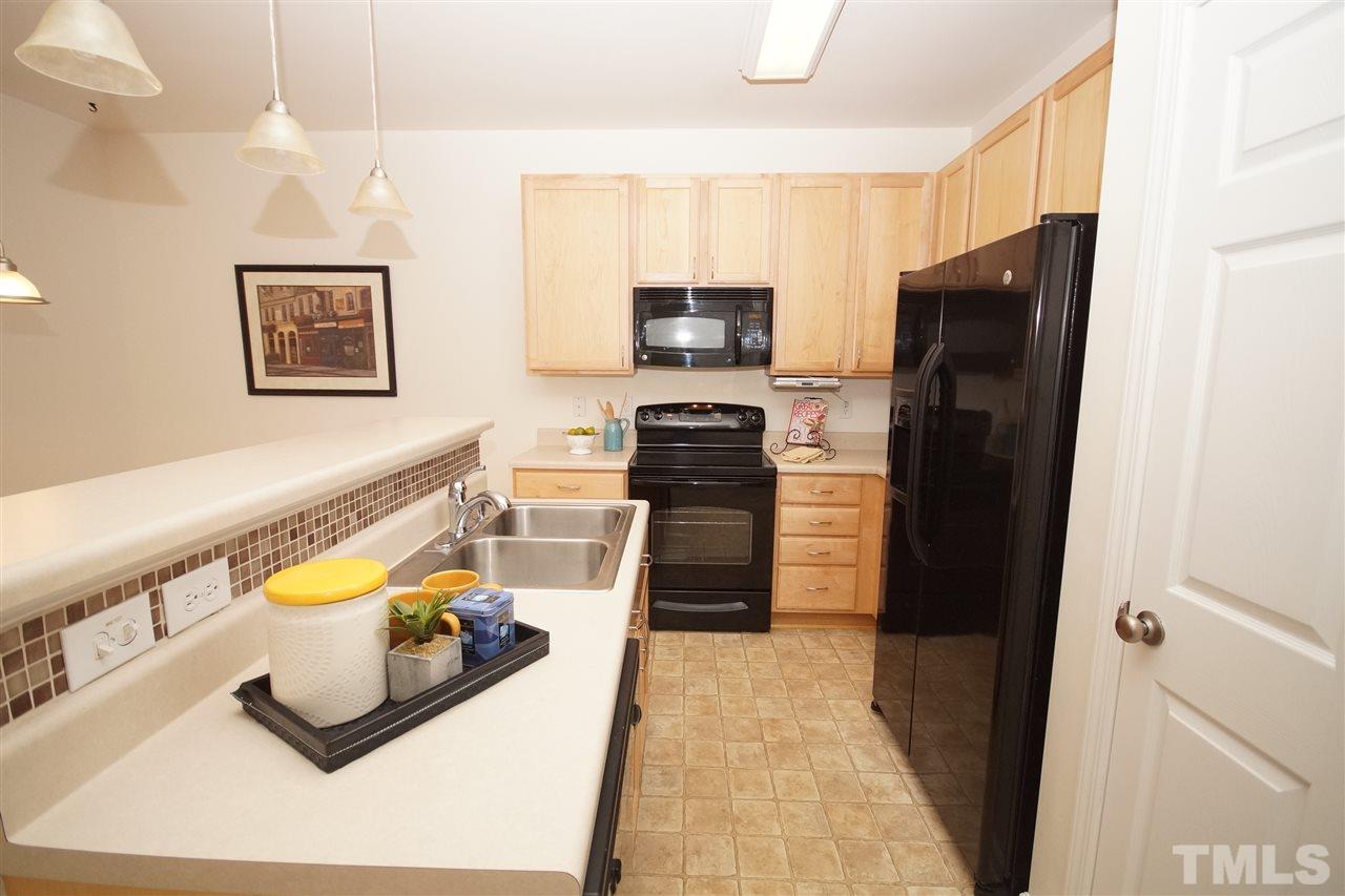 8235 Belneath Court Raleigh, NC 27613 - Photo 8 of 17 a kitchen with stainless steel appliances granite countertop a refrigerator and a stove