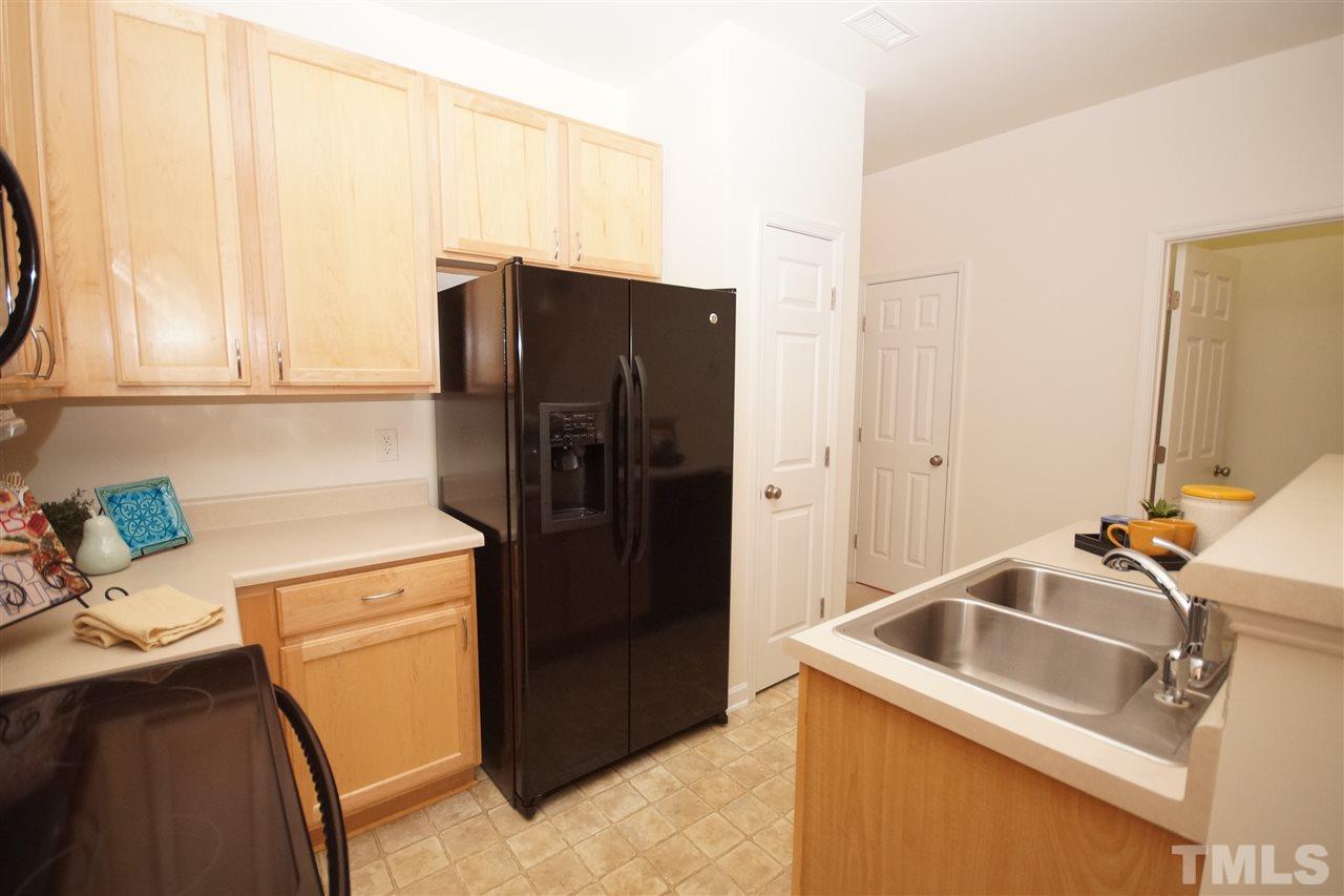 8235 Belneath Court Raleigh, NC 27613 - Photo 9 of 17 a kitchen with a refrigerator sink and stove