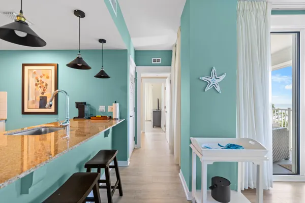 a dining room with furniture and a chandelier
