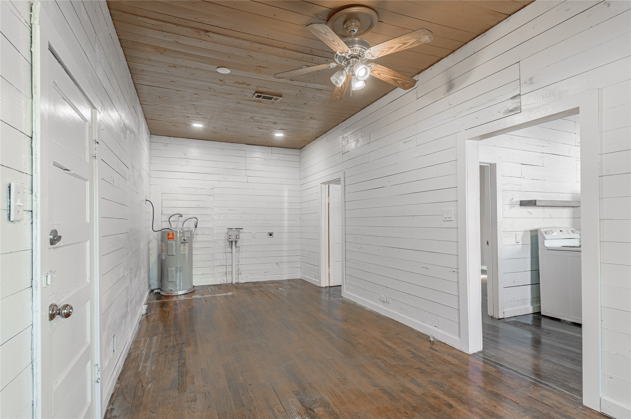 703 Avenue J Huntsville, TX 77320 - Photo 13 of 26 wooden floor in an empty room