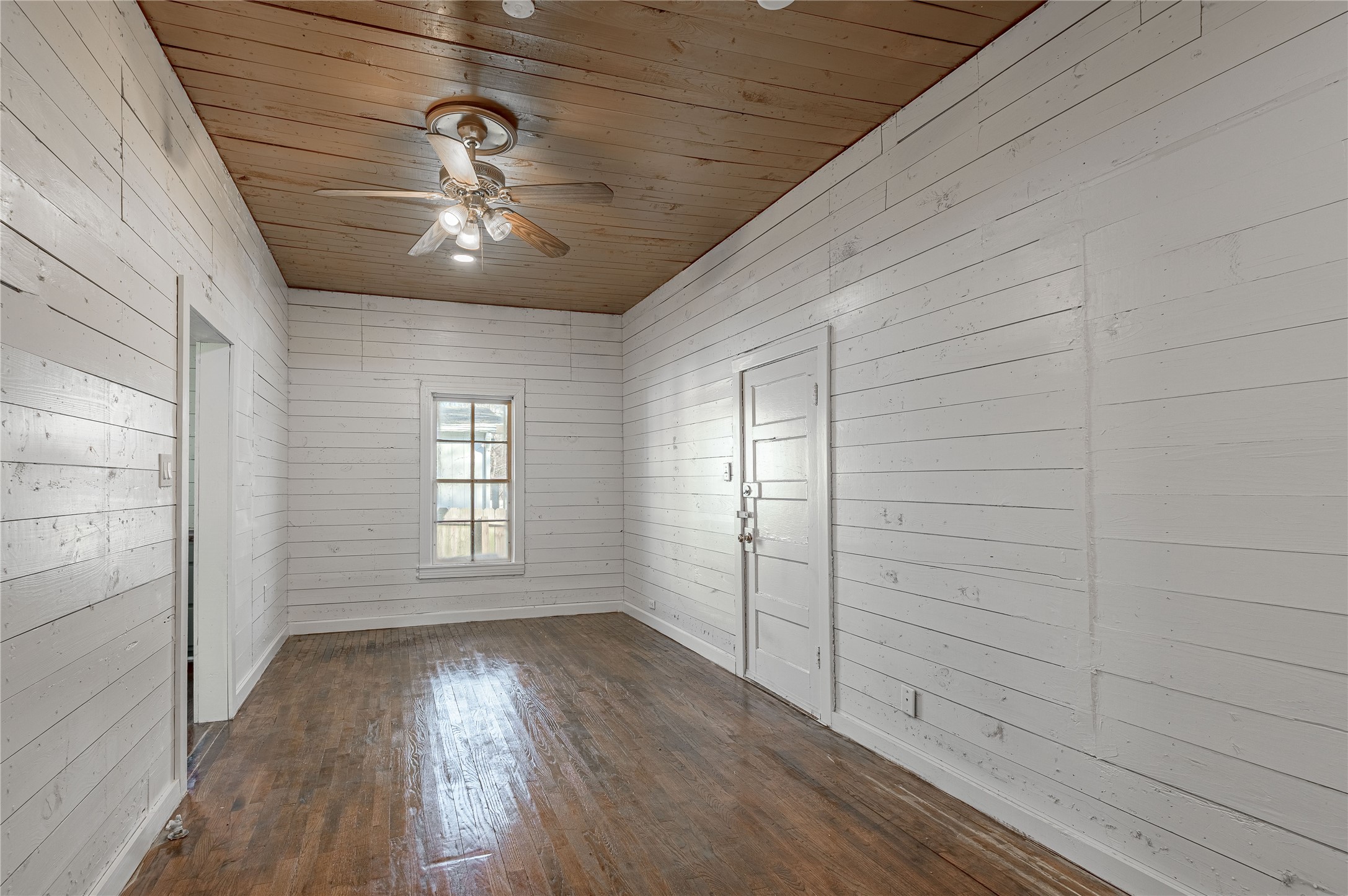 703 Avenue J Huntsville, TX 77320 - Photo 14 of 26 a view of empty room with wooden floor and fan