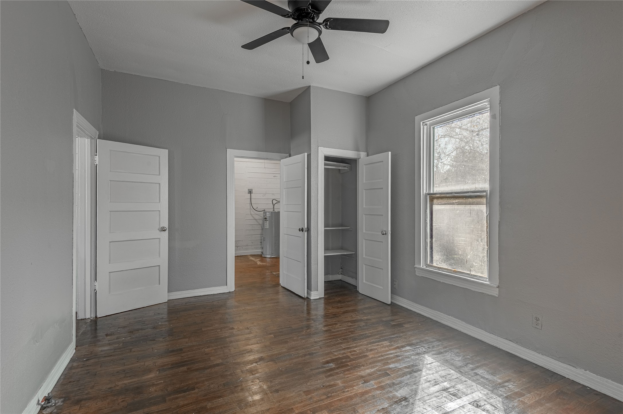 703 Avenue J Huntsville, TX 77320 - Photo 16 of 26 a view of empty room with wooden floor and window
