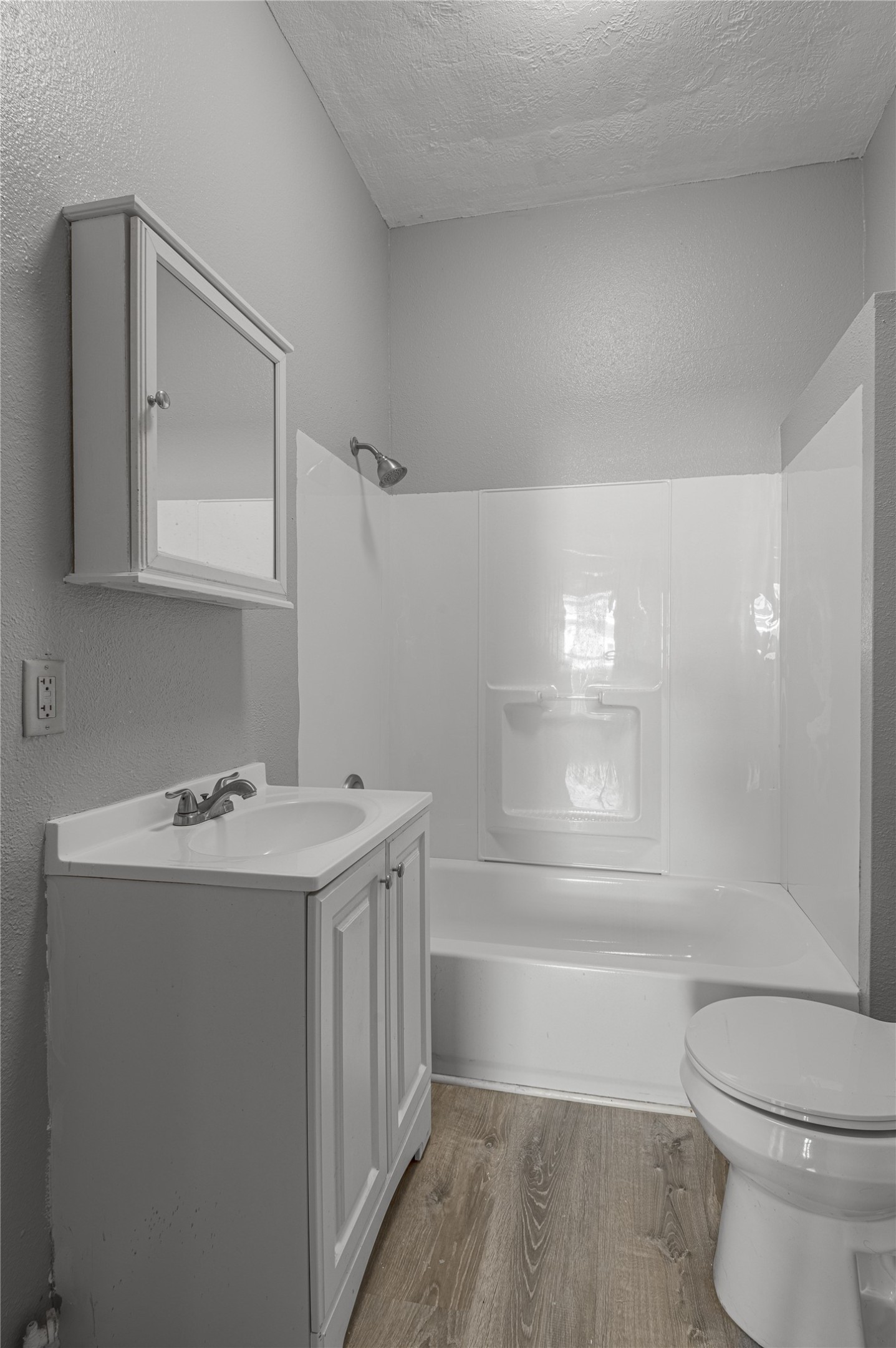 703 Avenue J Huntsville, TX 77320 - Photo 18 of 26 a bathroom with a sink a toilet and shower