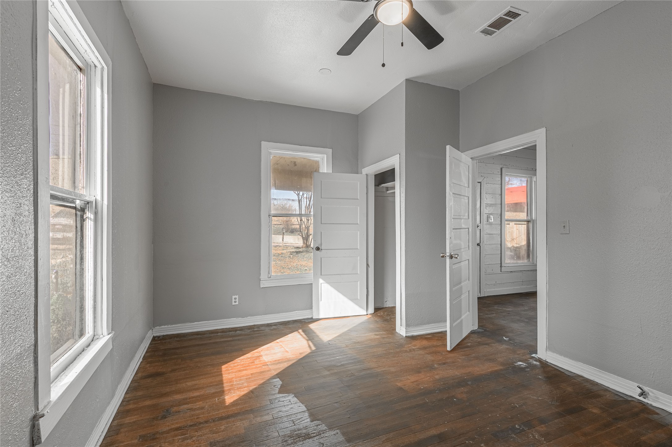 703 Avenue J Huntsville, TX 77320 - Photo 20 of 26 a view of empty room with wooden floor and fan