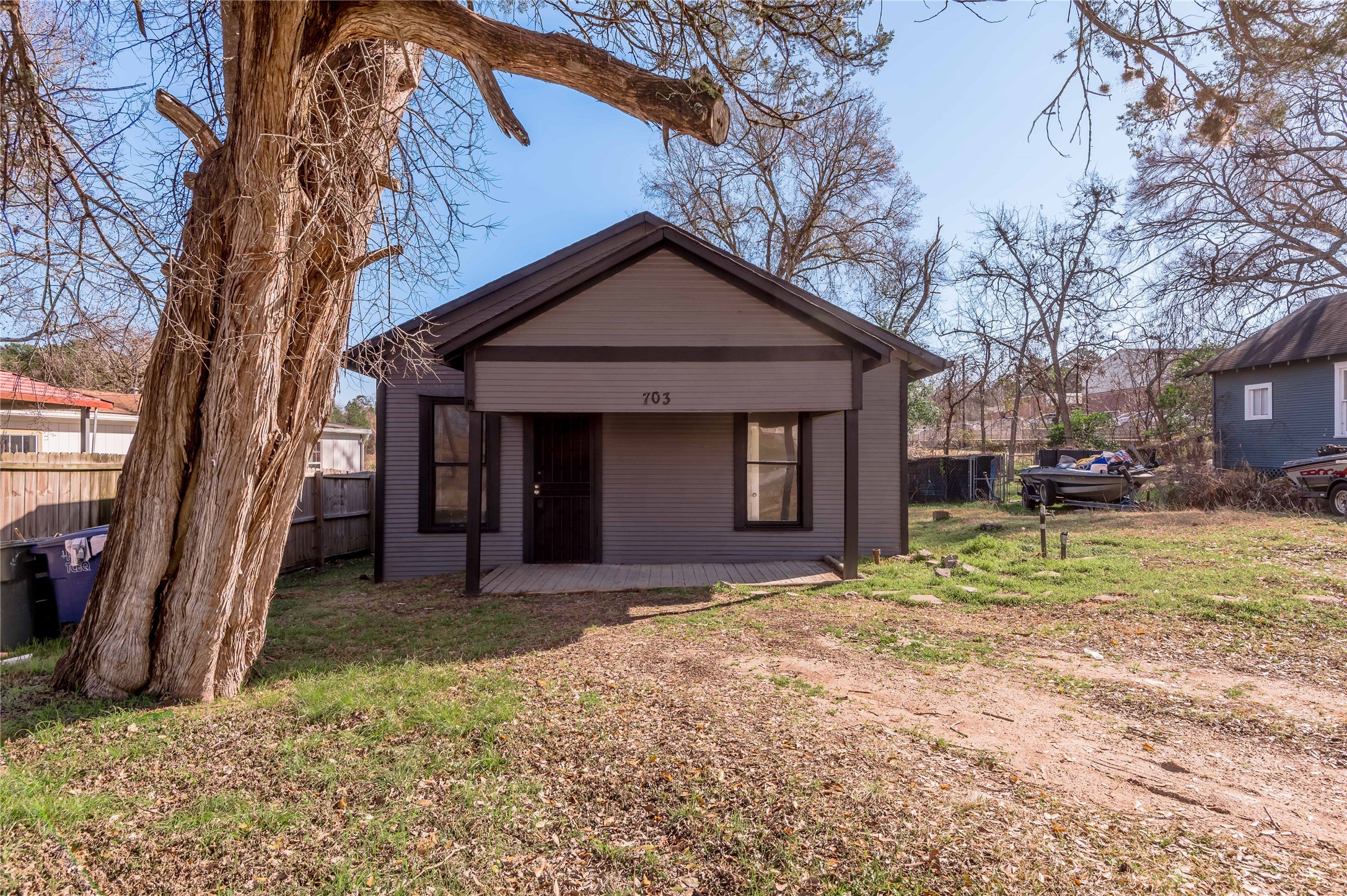 703 Avenue J Huntsville, TX 77320 - Photo 2 of 26 a view of a house with a yard and large tree