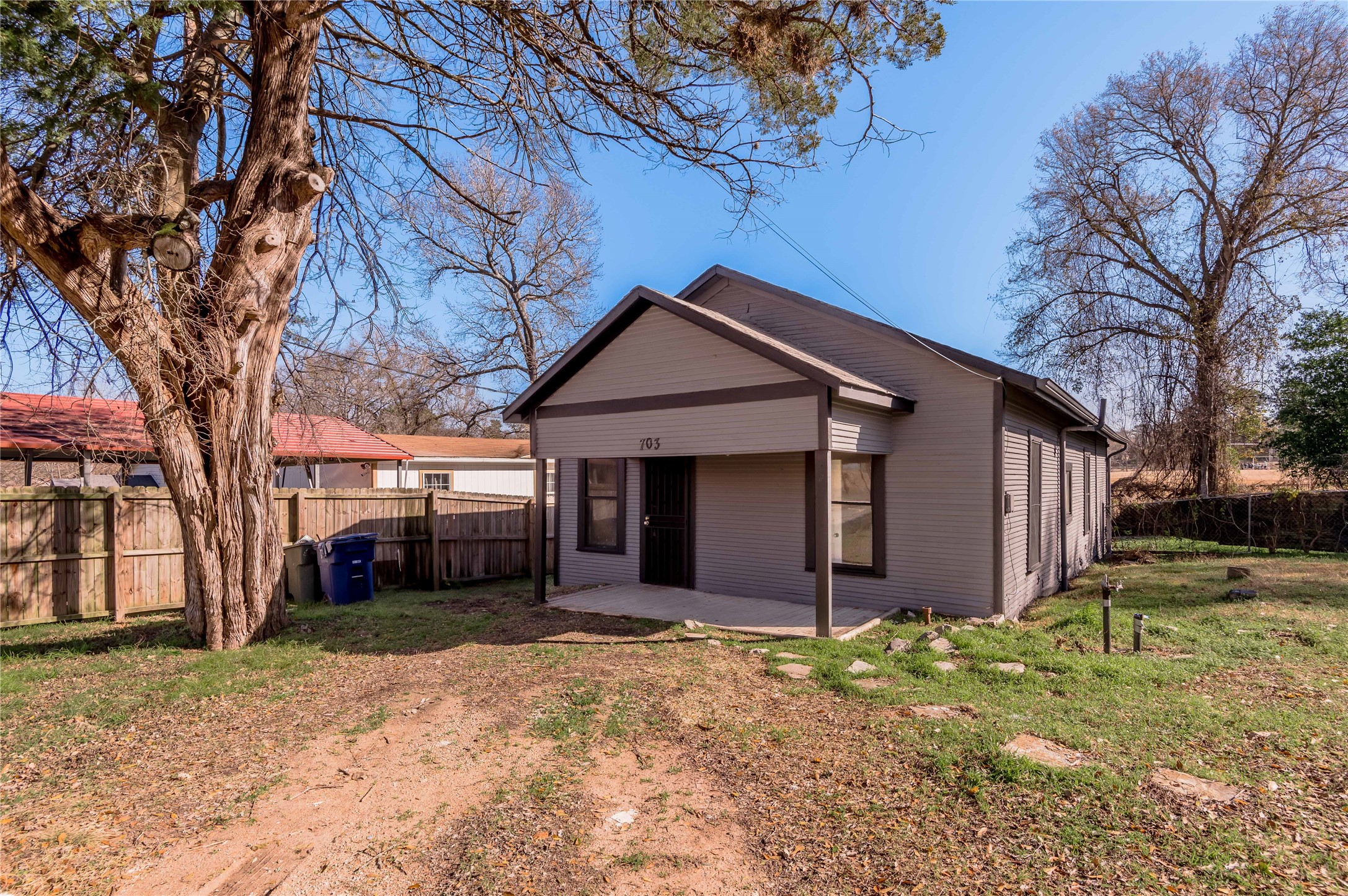 703 Avenue J Huntsville, TX 77320 - Photo 22 of 26 a front view of house with a yard and garage