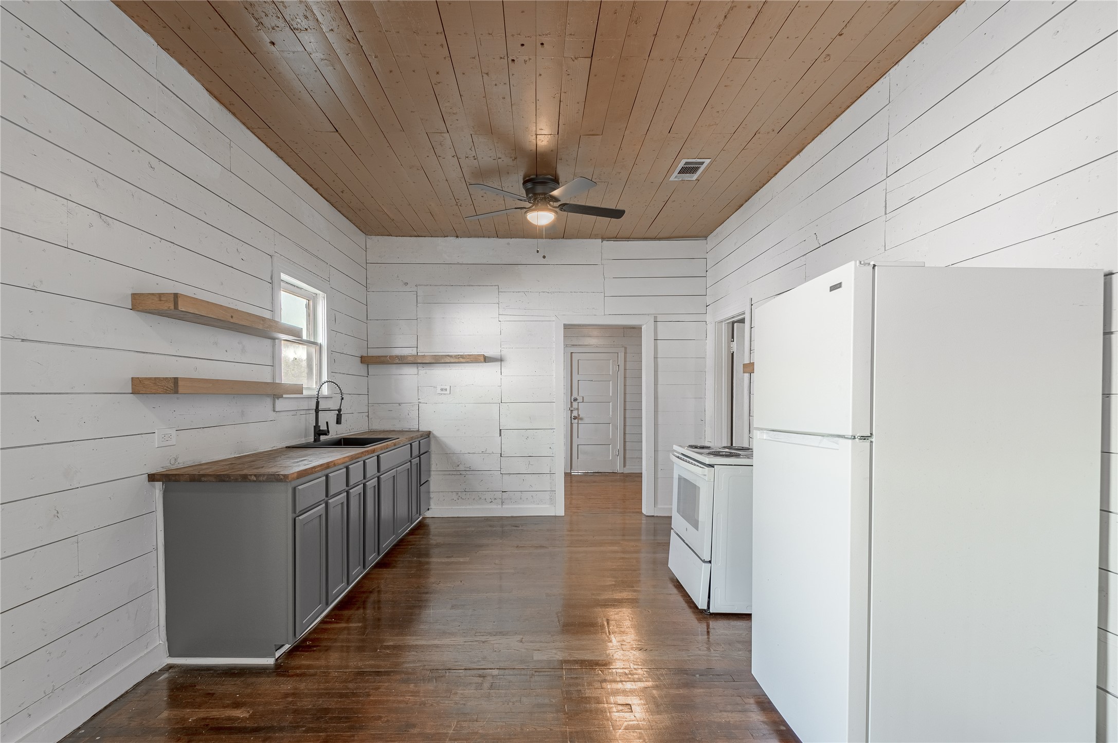 703 Avenue J Huntsville, TX 77320 - Photo 8 of 26 a kitchen with stainless steel appliances a refrigerator and a sink