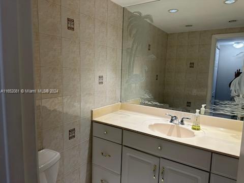 4716 Southwest 67th Avenue, Unit D2 Miami, FL 33155 - Photo 6 of 10 a bathroom with a sink toilet a mirror and shower