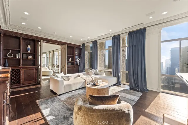 a living room with fireplace furniture and a rug