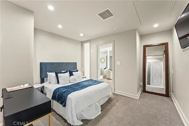 a bedroom with a bed and a night stand