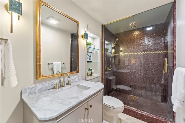 a bathroom with a granite countertop sink a toilet a mirror and shower