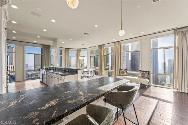 a large dining space with furniture window and wooden floor