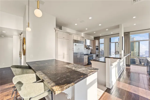 a kitchen with a refrigerator and a counter top space