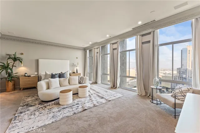 a living room with furniture and large windows