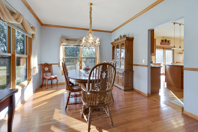 14N600 Timber Ridge Drive Elgin, IL 60124 - Photo 12 of 28 a view of a dining room with furniture wooden floor and chandelier