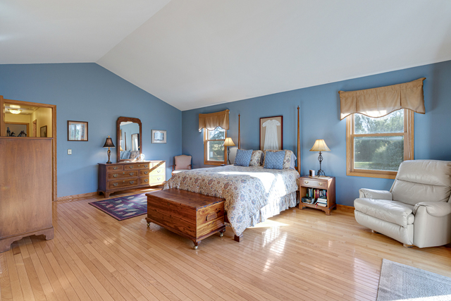 14N600 Timber Ridge Drive Elgin, IL 60124 - Photo 20 of 28 a spacious bedroom with a bed and wooden floor