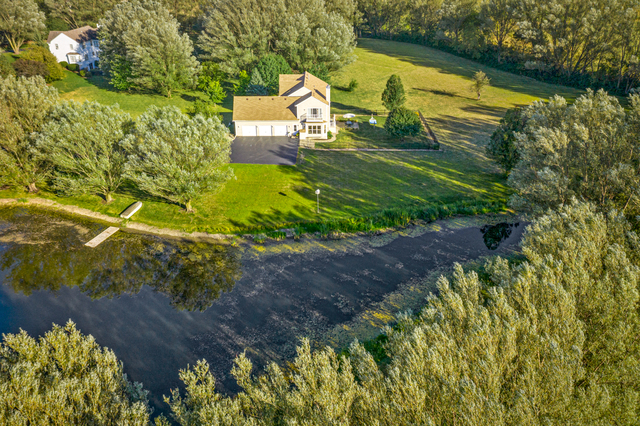 14N600 Timber Ridge Drive Elgin, IL 60124 - Photo 3 of 28 a view of a lake with a house in the background