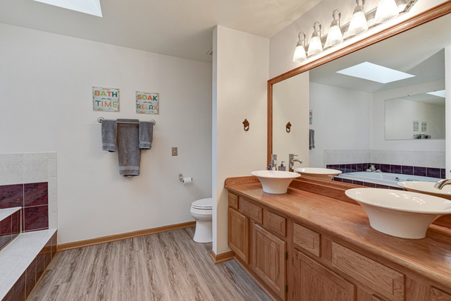 14N600 Timber Ridge Drive Elgin, IL 60124 - Photo 26 of 28 a bathroom with a granite countertop sink a toilet and a mirror