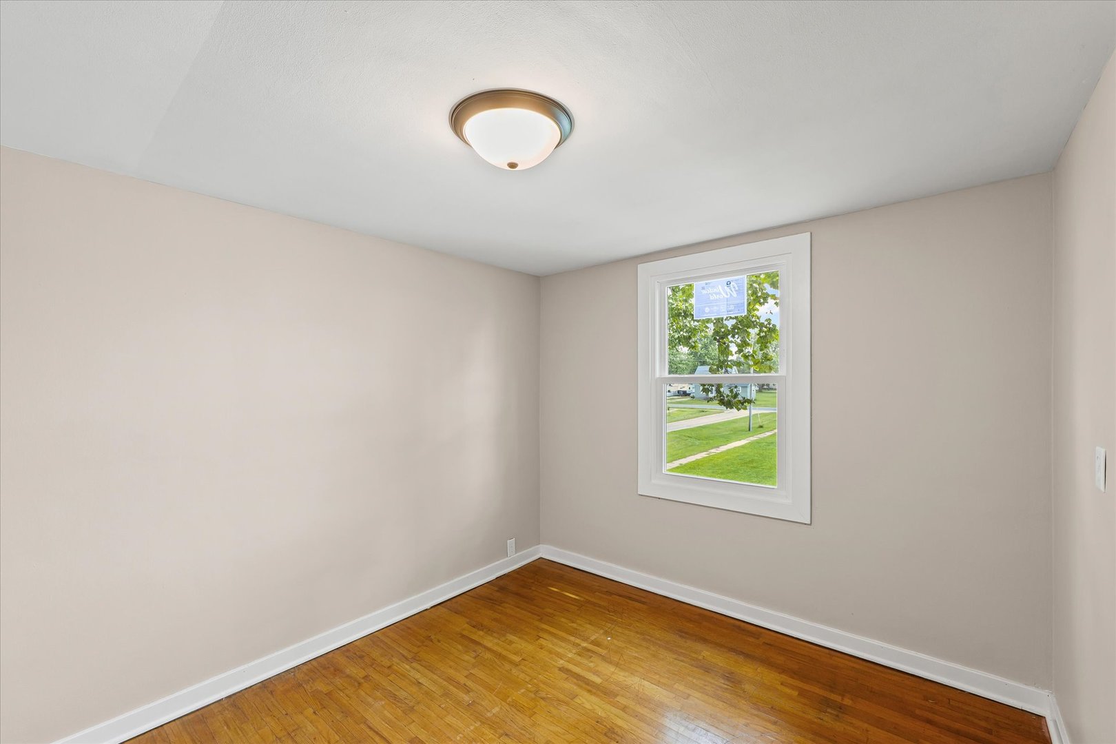 105 Madison Street Sibley, IL 61773 - Photo 14 of 22 a view of a room with wooden floor and window