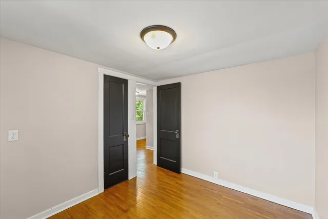 a view of livingroom with hallway and wooden floor