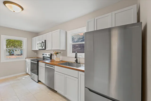a kitchen with stainless steel appliances a refrigerator sink and cabinets