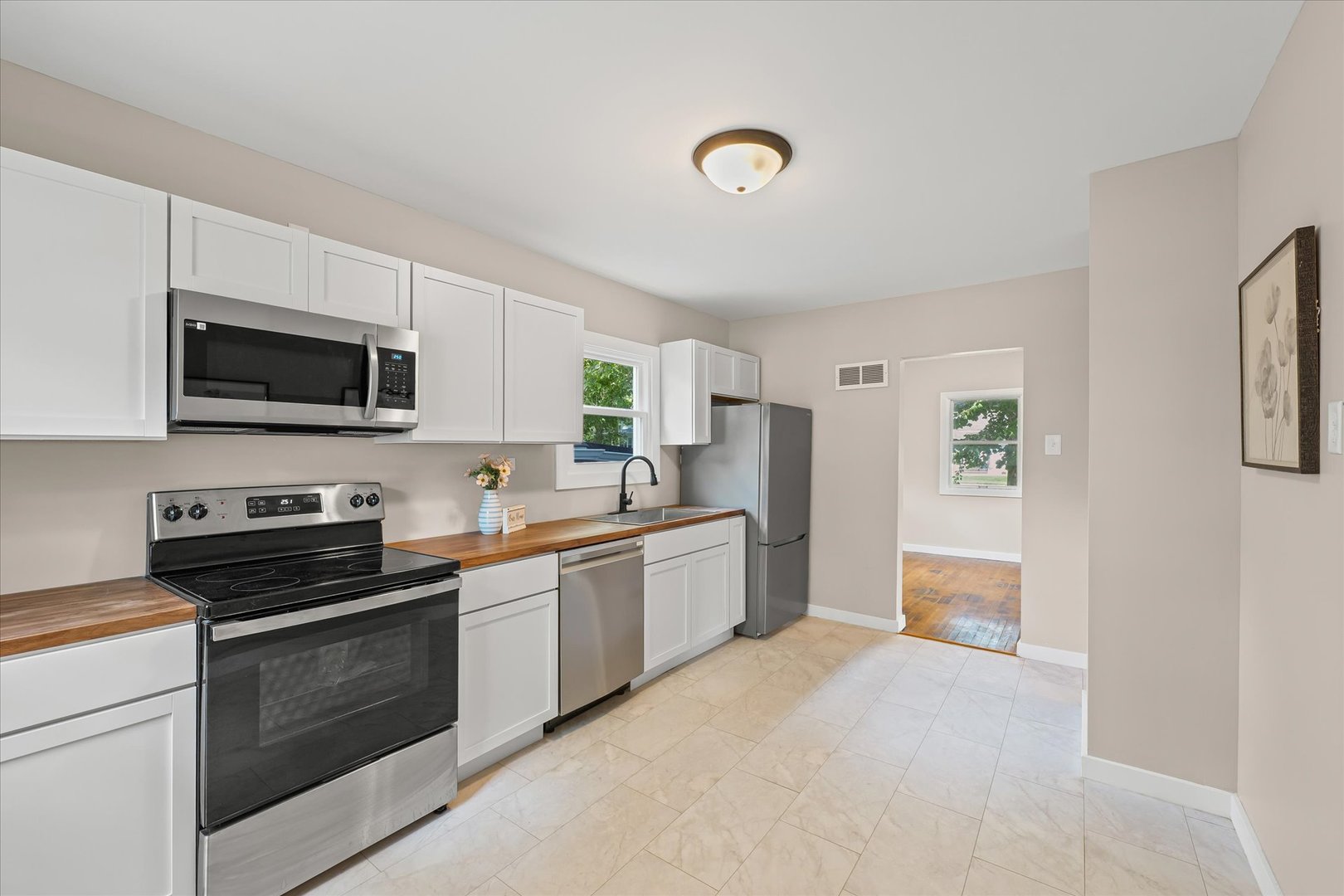105 Madison Street Sibley, IL 61773 - Photo 8 of 22 a kitchen with stainless steel appliances a stove sink microwave and refrigerator