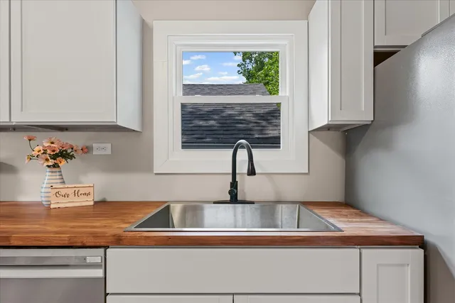 a kitchen with granite countertop a sink and a stove