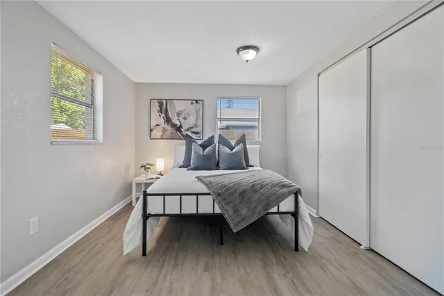 a bedroom with a bed and wooden floor